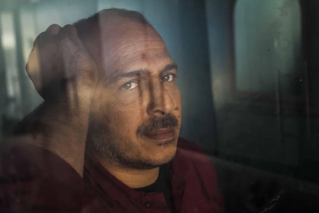 Person sitting by a window in a quiet reflective moment